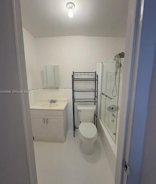 A small bathroom features a white vanity, a toilet with a metal rack, and a shower — 5641 SW 39th St, West Park FL 33023, WEST PARK, FL