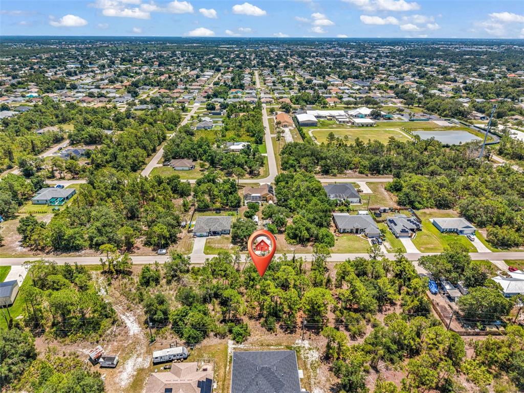 An aerial view shows a residential neighborhood with a red house icon marking a property — 325 WYLER STREET, PORT CHARLOTTE, FL