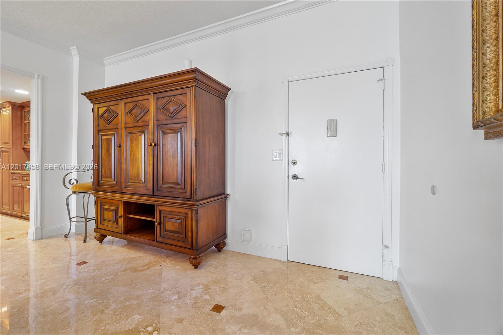 A wooden armoire stands on a tiled floor next to a white entry door — 2851 S Ocean Blvd # 7U, Boca Raton FL 33432, BOCA RATON, FL
