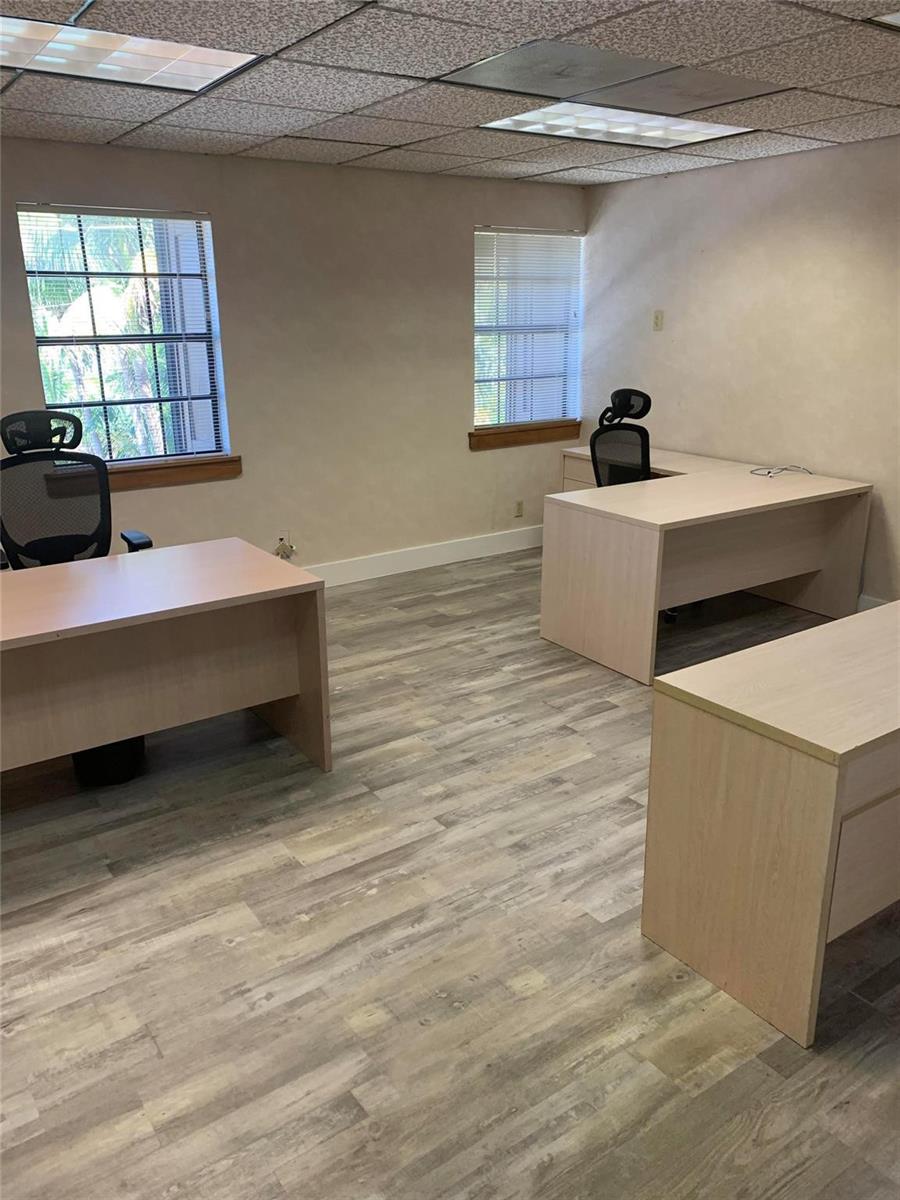 An office space features light wood-look flooring, beige walls, drop ceilings, and three desks — 1200 S Federal Highway, Boynton Beach FL 33435, BOYNTON BEACH, FL