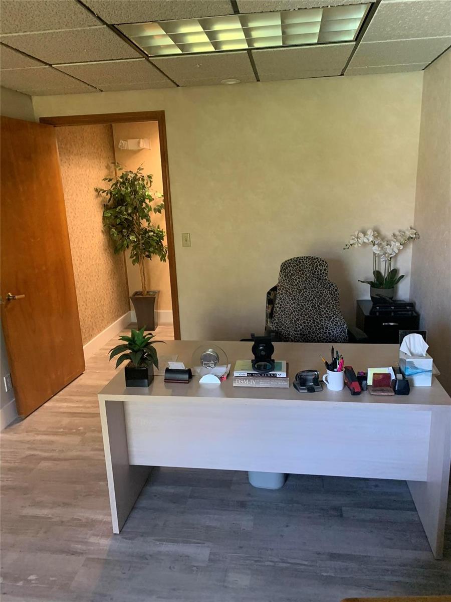 A home office features a light wood desk, leopard-print chair, and wood-look flooring — 1200 S Federal Highway, Boynton Beach FL 33435, BOYNTON BEACH, FL