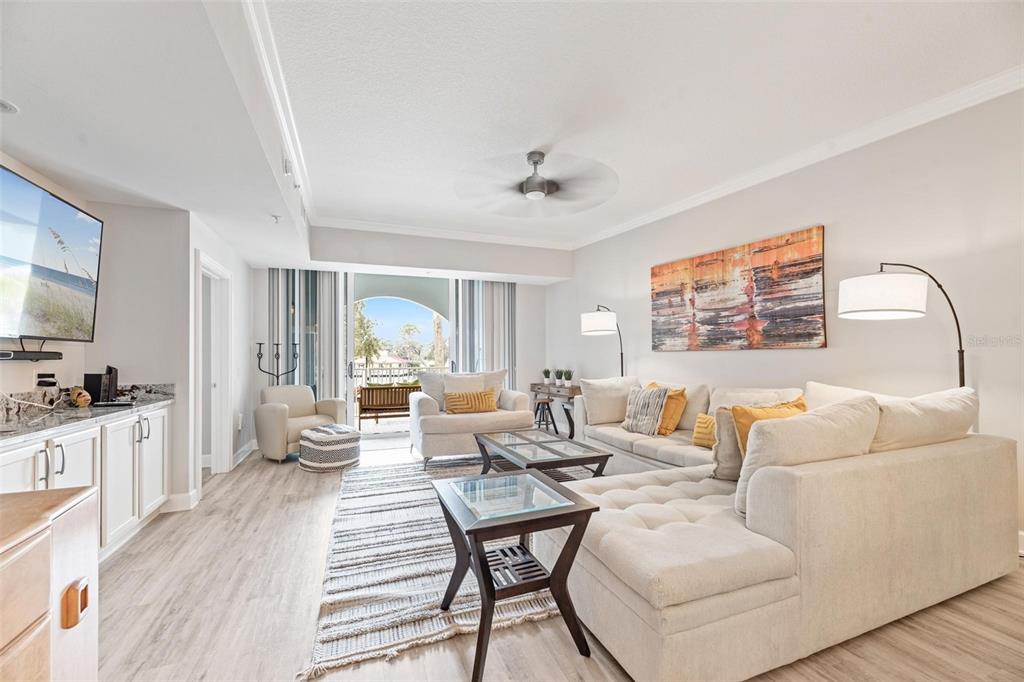A bright living room features a sectional sofa, glass-topped tables, and a sliding door balcony — 102 YACHT HARBOR DRIVE UNIT 176, PALM COAST, FL