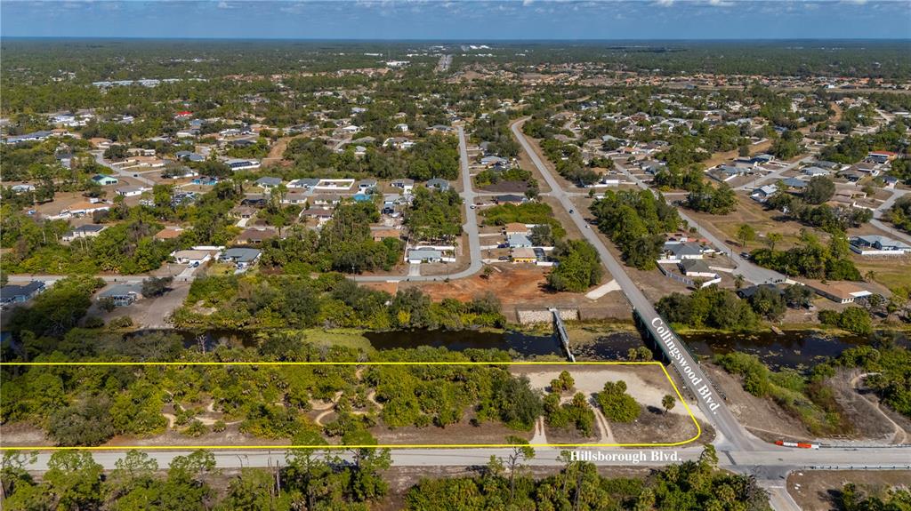 An aerial view shows a vacant, wooded lot bordered by Hillsborough Blvd and Collingswood Blvd — W HILLSBOROUGH BOULEVARD, NORTH PORT, FL