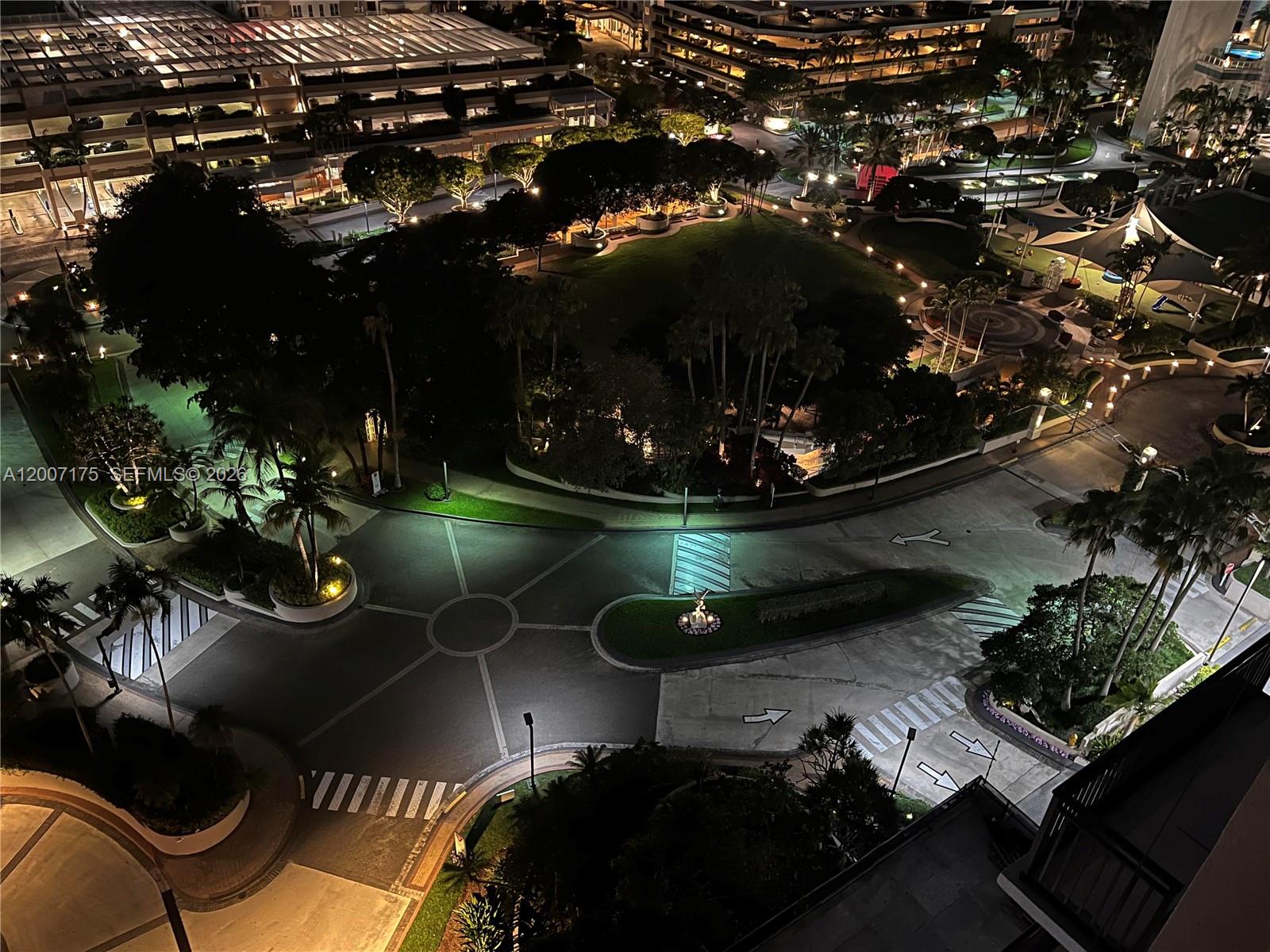 An elevated night view shows a landscaped park area with pathways and surrounding paved roads — 540 Brickell Key Dr # 1809, Miami FL 33131, MIAMI, FL