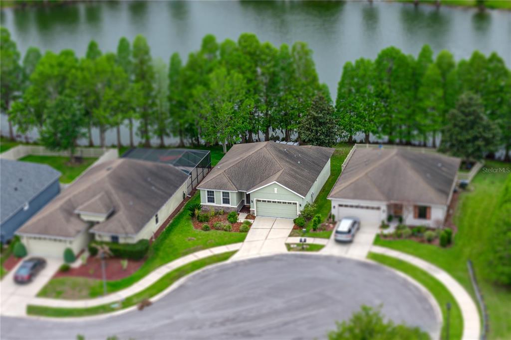 An aerial view shows a suburban house with a green exterior and a two-car garage — 5544 HURON WAY, LAKELAND, FL