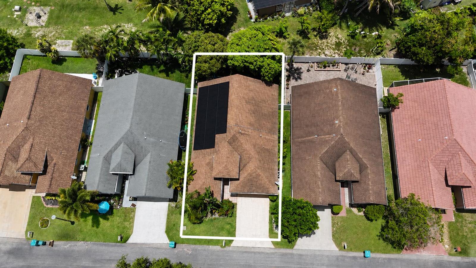 An aerial view shows a single-family home with solar panels on its brown shingled roof — 1059 Fairfax Circle W, Boynton Beach FL 33436, BOYNTON BEACH, FL