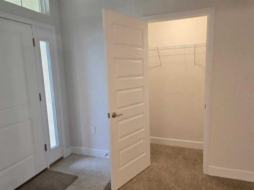 A room with a white door opening into a walk-in closet with wire shelving — 825 W HALLAM DRIVE, CITRUS SPRINGS, FL