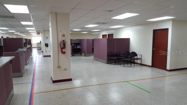 An office space features rows of cubicles, a fire extinguisher on a pillar, and tiled floors — 602 BARBOSA AVE, SAN JUAN, PR