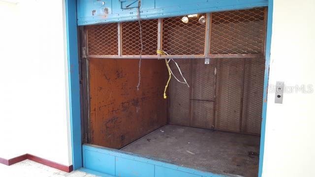 An industrial-style freight elevator with a blue metal frame and wire mesh upper panels — 602 BARBOSA AVE, SAN JUAN, PR