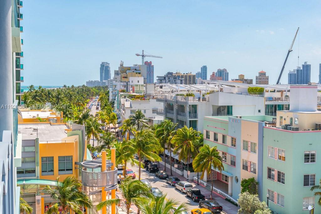 An elevated view of a sunny street lined with palm trees and colorful Art Deco buildings — 1500 Ocean Drive # 609, Miami Beach FL 33139, MIAMI BEACH, FL