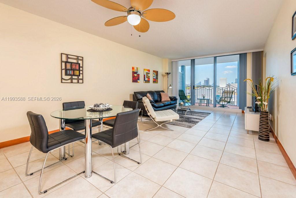 A living and dining area features tile floors, a glass table, and a balcony view — 1500 Ocean Drive # 609, Miami Beach FL 33139, MIAMI BEACH, FL
