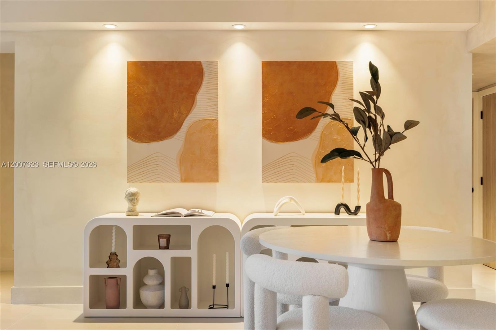 A dining room features two abstract paintings above a white arched console table — 2301 Collins Ave # 526, Miami Beach FL 33139, MIAMI BEACH, FL
