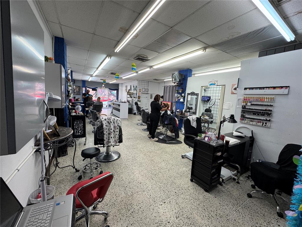 A hair and nail salon interior featuring multiple styling chairs, workstations, and a tiled floor — 8 DR. VIDAL, HUMACAO, PR