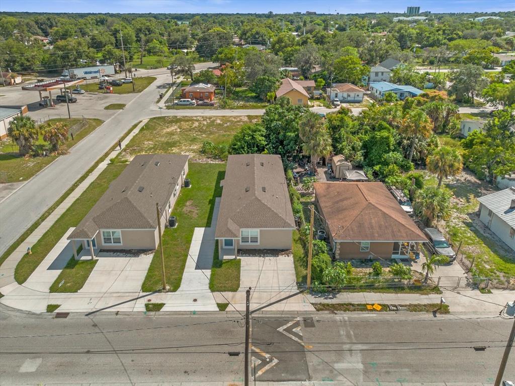 An aerial view shows three adjacent houses with driveways along a paved road — 324 AVENUE Y NE UNIT B, WINTER HAVEN, FL