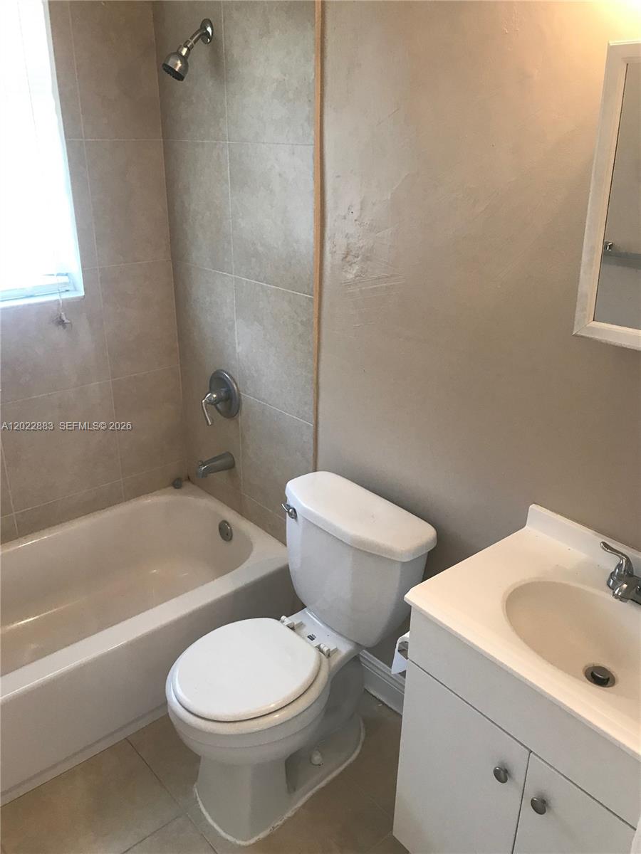 This bathroom features a white vanity, a toilet, and a bathtub with tiled walls — 13315 Alexandria Dr # 3, Opa-Locka FL 33054, OPA-LOCKA, FL
