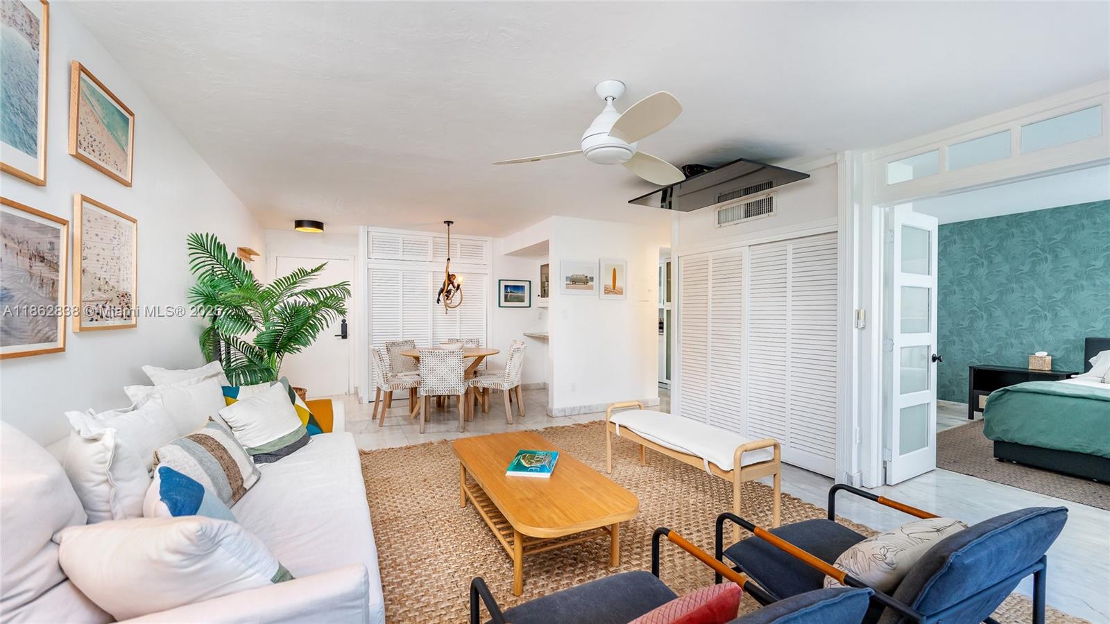 A bright living room features a white sofa, wooden coffee table, and adjacent dining area — 195 Sunrise Dr # 1, Key Biscayne FL 33149, KEY BISCAYNE, FL