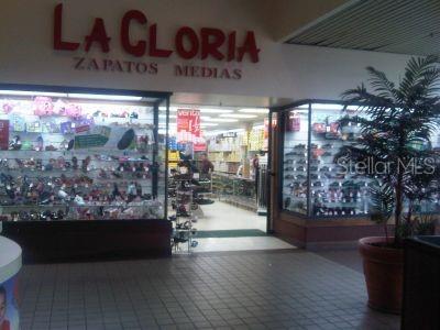 The storefront of a shoe store named La Gloria features glass display windows and tile flooring — 167 PR 167 INT. BETANCES ST., BAYAMON, PR
