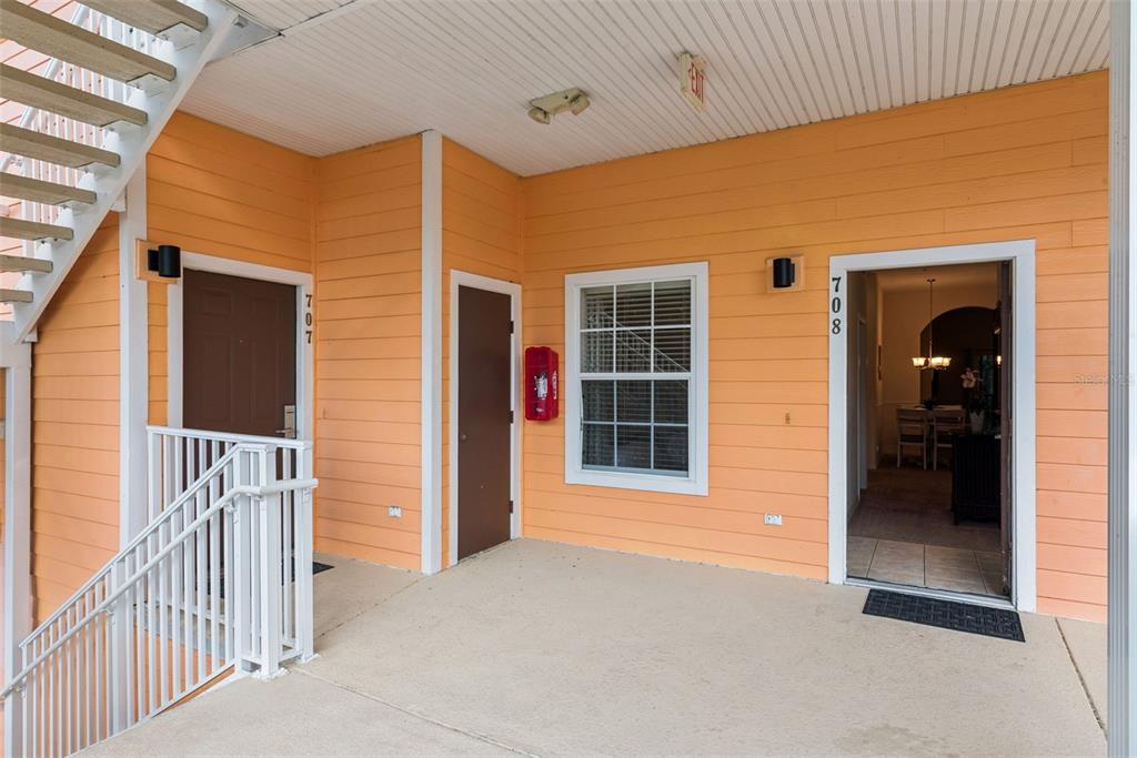 An exterior view of a building entrance with two doors numbered 707 and 708 — 708 NEW PROVIDENCE PROMENADE, DAVENPORT, FL