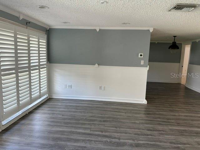 A room with gray and white walls, wood-look flooring, and white plantation shutters — 10840 NORWOOD AVENUE, PORT RICHEY, FL