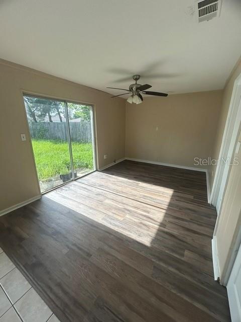 A room with wood-look flooring, a ceiling fan, and a sliding glass door to a yard — 222 ALBERT STREET, WINTER SPRINGS, FL