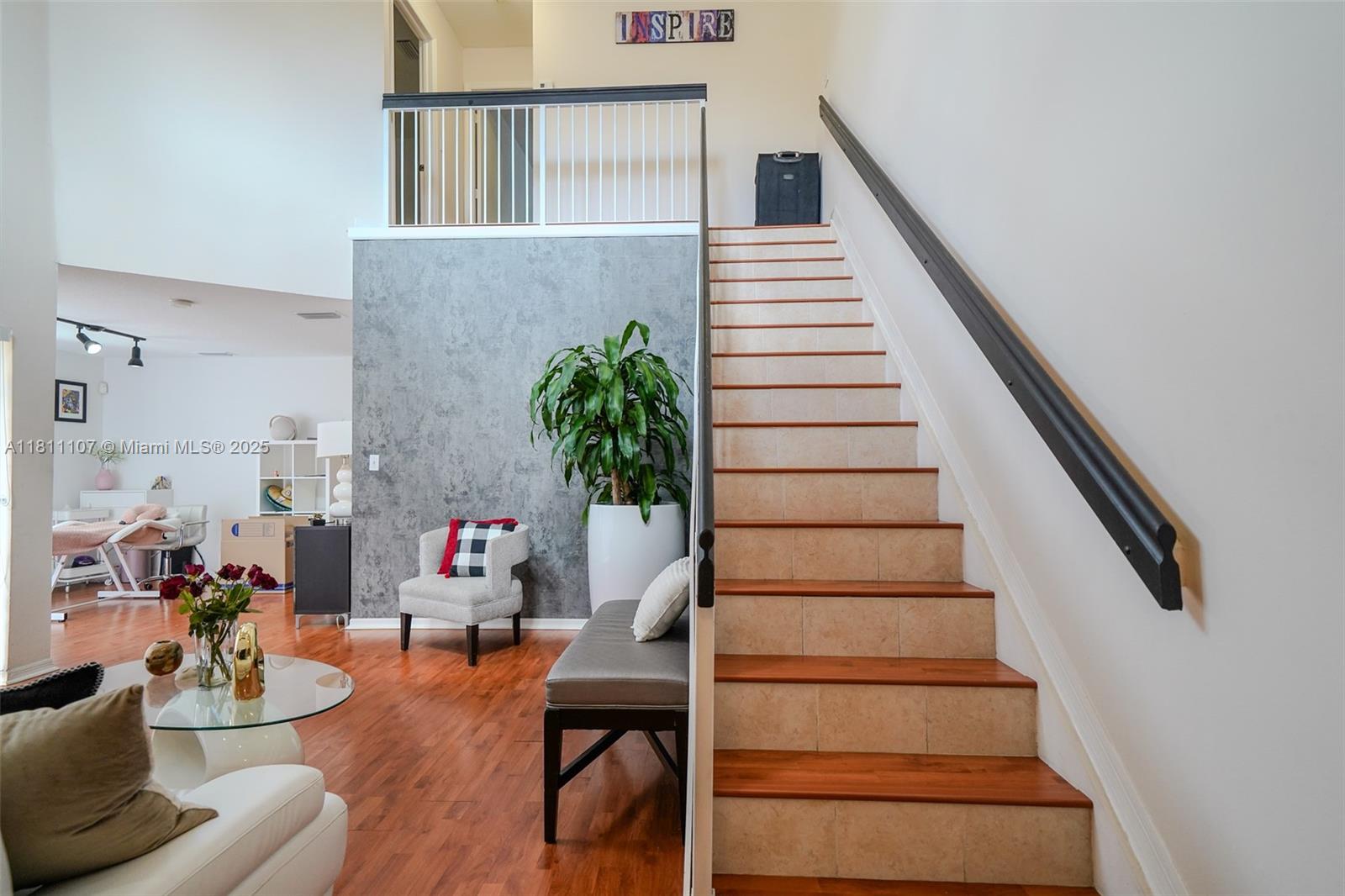 A staircase with wooden treads and tiled risers sits beside a gray accent wall — 14816 SW 104th St # 85, Miami FL 33196, MIAMI, FL