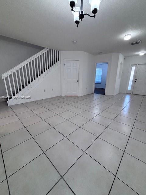 A bright room with white tile floors, a staircase with white railings, and interior doors — 13726 SW 171st Ln, Miami FL 33177, MIAMI, FL