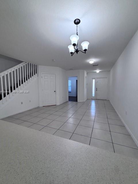 An interior view shows a tiled dining area with a chandelier and a staircase — 13726 SW 171st Ln, Miami FL 33177, MIAMI, FL