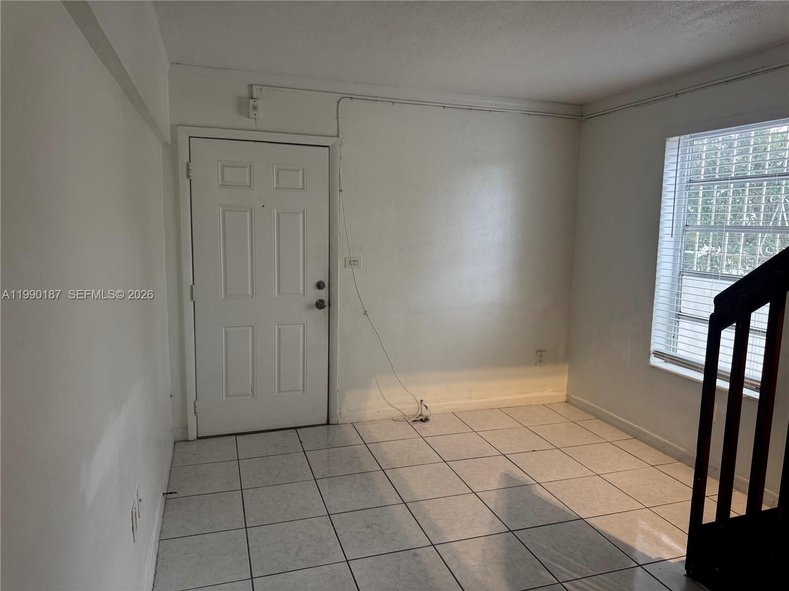 A room with white walls, tiled flooring, a white door, and a window with blinds — 11 SW 32nd Ave # 4, Miami FL 33135, MIAMI, FL