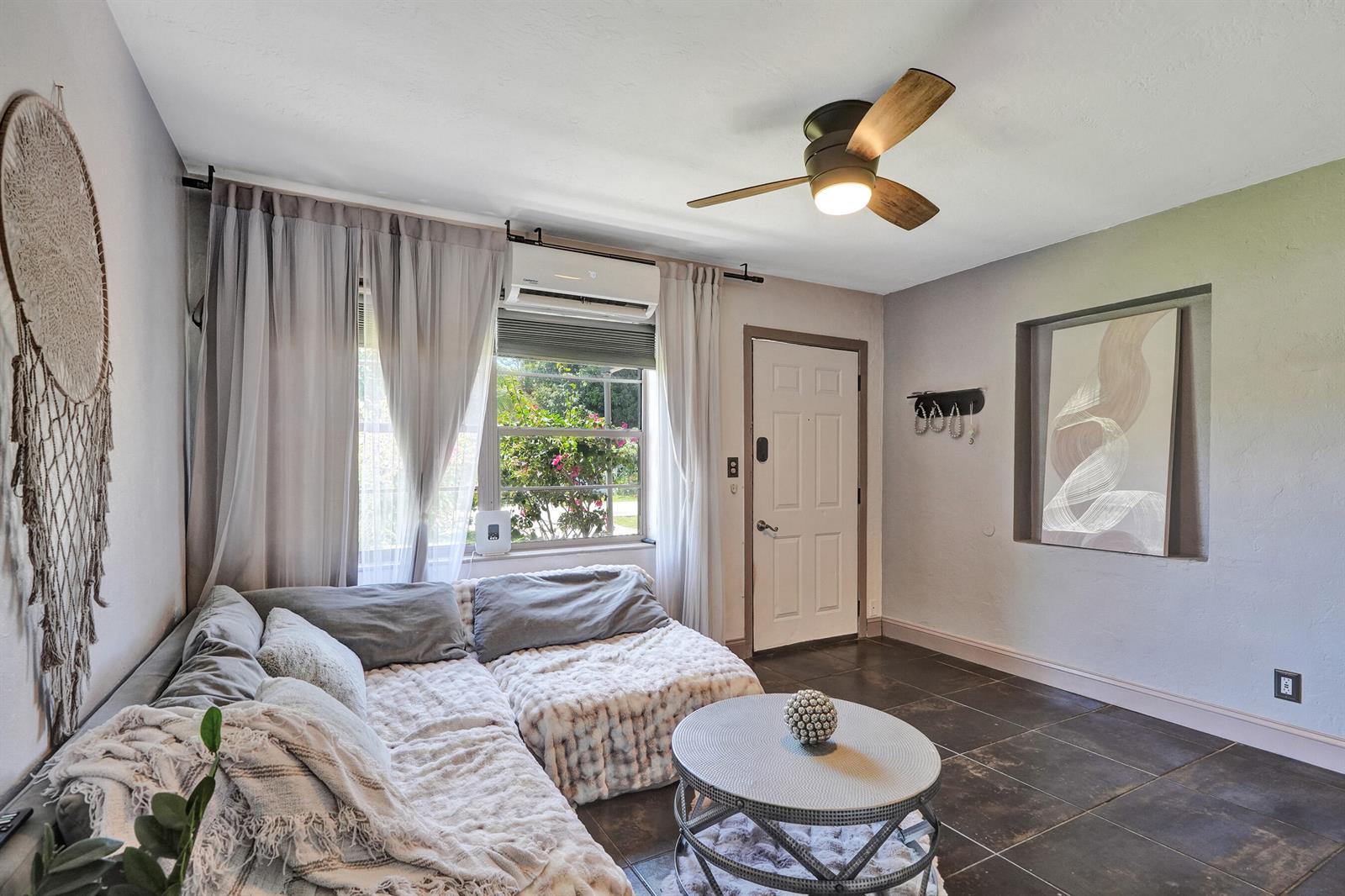 A living room features a sectional sofa, a round coffee table, and a ceiling fan — 1465 NE 27th Street, Pompano Beach FL 33064, POMPANO BEACH, FL