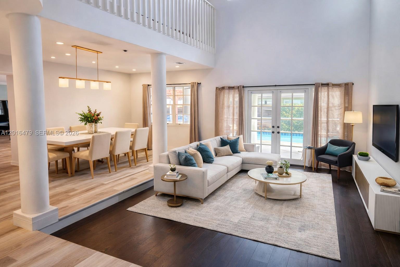 A sunken living room with a sectional sofa sits adjacent to a raised dining area — 14231 SW 36th St, Miami FL 33175, MIAMI, FL