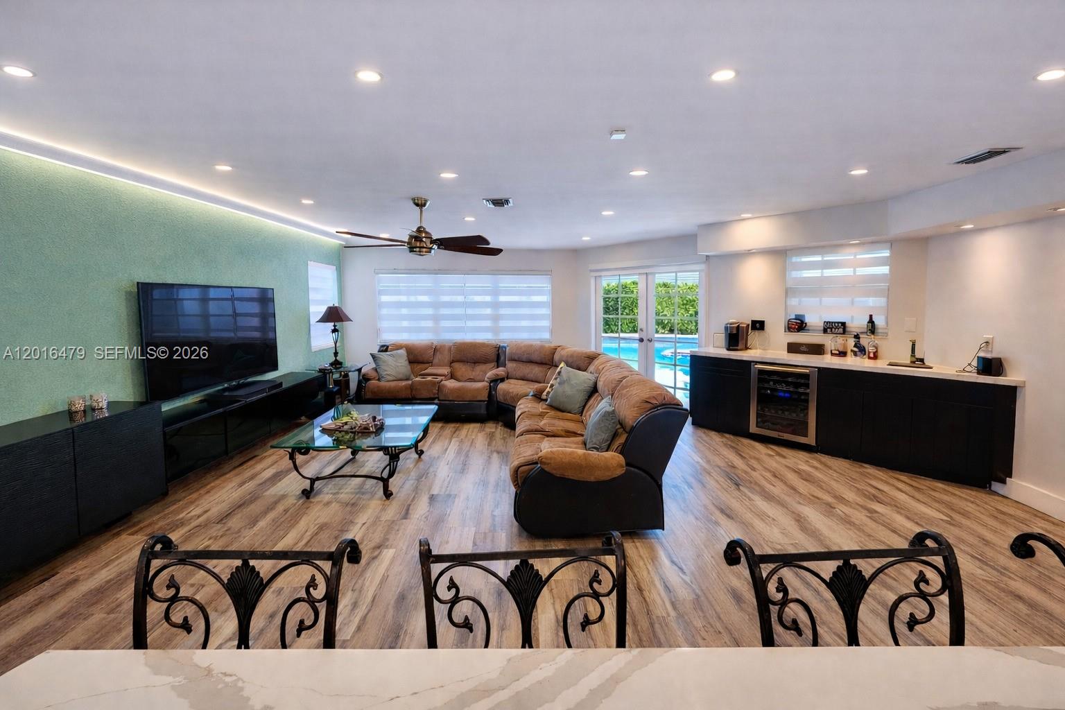 A living room features a large sectional sofa, a television, and a built-in wet bar — 14231 SW 36th St, Miami FL 33175, MIAMI, FL