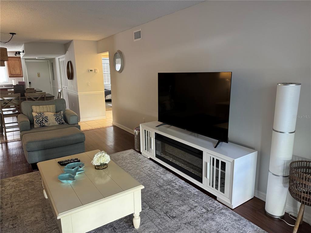 A kitchen features wood cabinets, stainless steel appliances, a center island, and light wood flooring — 1640 STICKNEY POINT ROAD UNIT 40-101, SARASOTA, FL