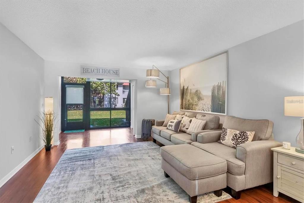 A bedroom features a bed with a light green throw, a ceiling fan, and television — 1640 STICKNEY POINT ROAD UNIT 40-101, SARASOTA, FL