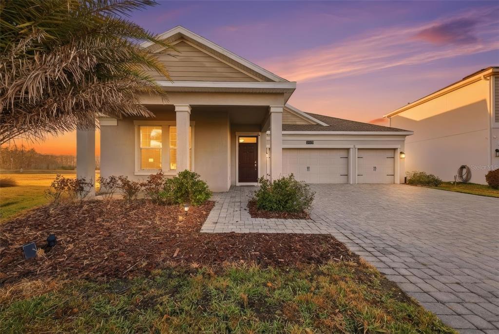 A single-story house with a paved driveway, two-car garage, and a covered front entryway — 4524 SEQUEL ROAD, KISSIMMEE, FL