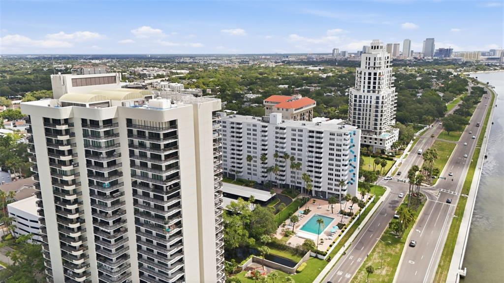 An aerial view shows several high-rise apartment buildings located next to a coastal road — 2413 BAYSHORE BOULEVARD UNIT 2001, TAMPA, FL