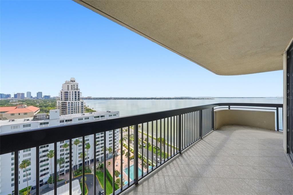 A high-rise balcony with a black metal railing overlooks a bay and city skyline — 2413 BAYSHORE BOULEVARD UNIT 2001, TAMPA, FL
