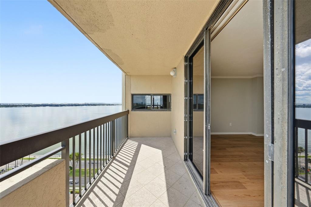 A balcony with a metal railing overlooks a large body of water — 2413 BAYSHORE BOULEVARD UNIT 2001, TAMPA, FL