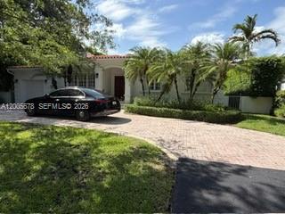 A single-story house with a red tile roof, white stucco exterior, and a paved driveway — 1237 Aduana Ave, Coral Gables FL 33146, CORAL GABLES, FL
