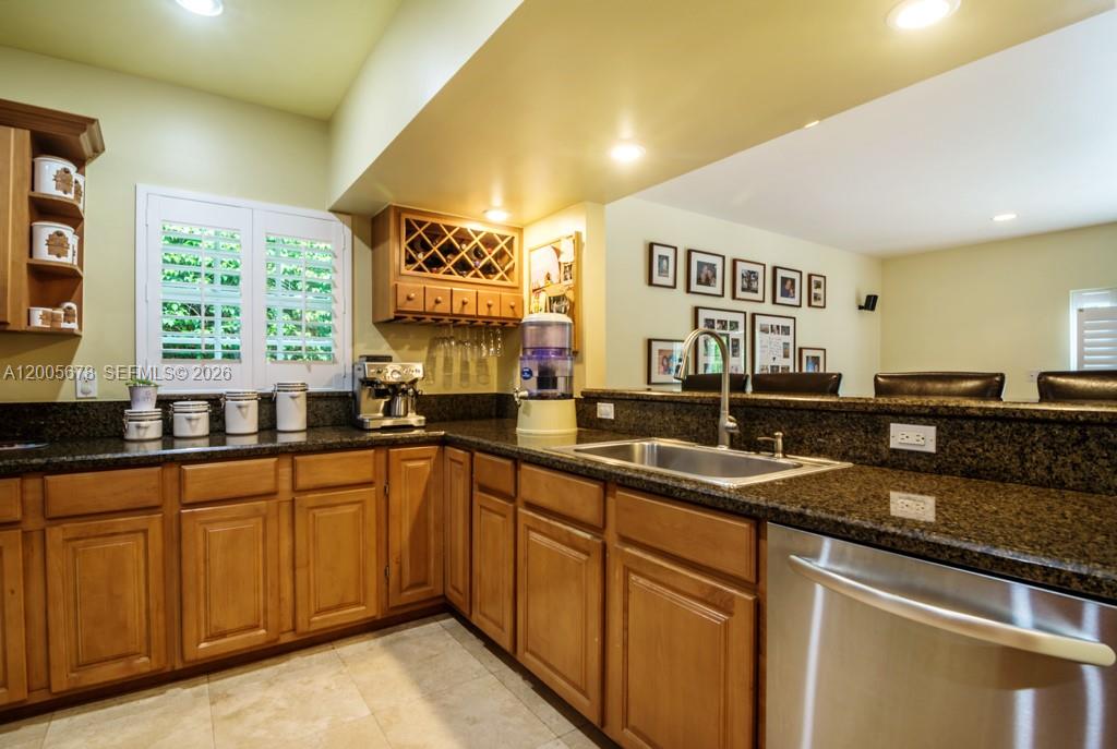 Open double wooden doors reveal an interior room with white walls and hardwood flooring — 1237 Aduana Ave, Coral Gables FL 33146, CORAL GABLES, FL