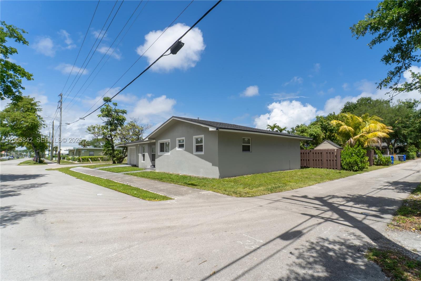 A single-story gray house with a white-trimmed exterior sits on a corner lot — 2260 Charleston St, Hollywood FL 33020, HOLLYWOOD, FL