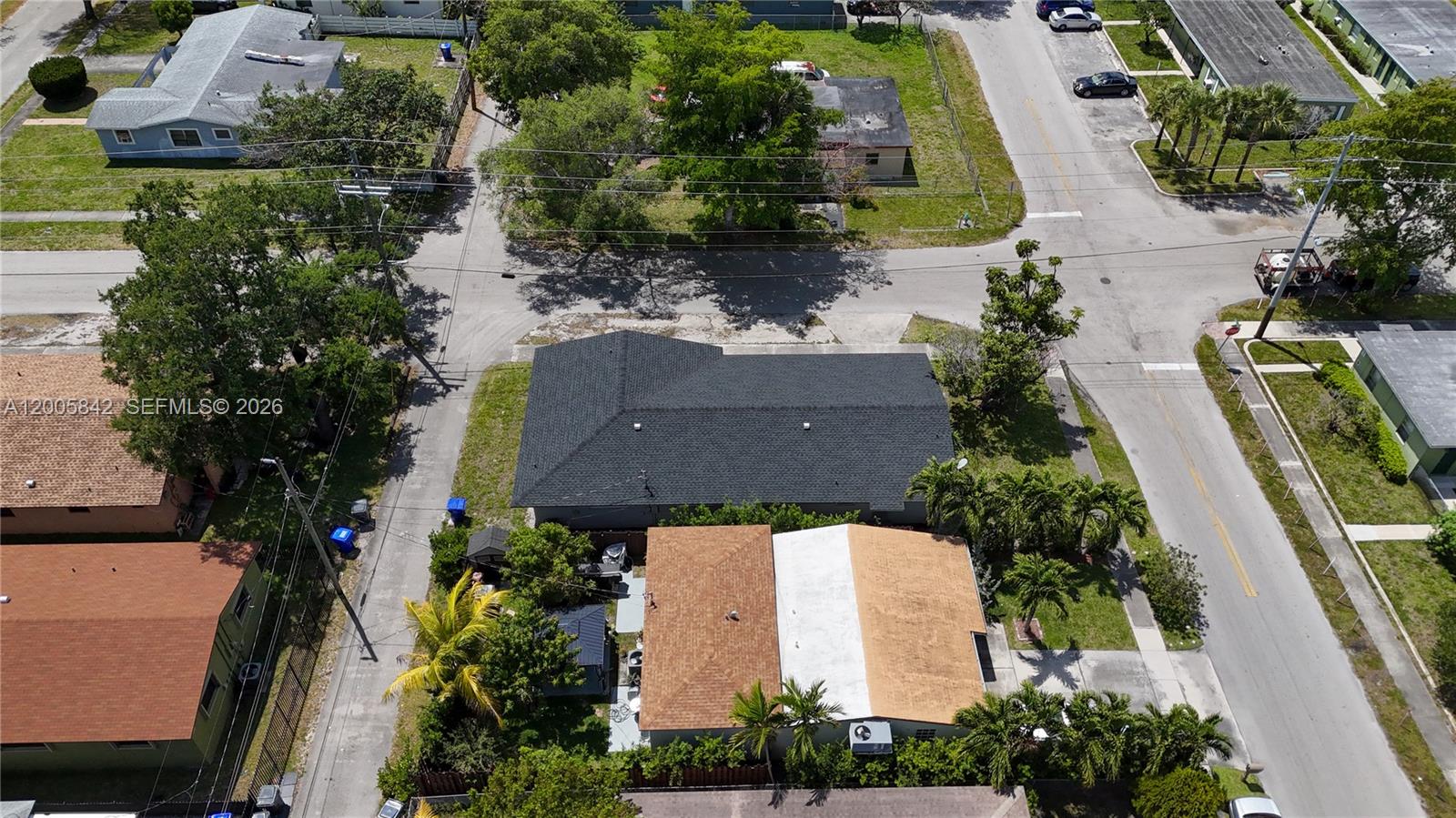 An aerial view shows a residential neighborhood with several houses, paved streets, and palm trees — 2260 Charleston St, Hollywood FL 33020, HOLLYWOOD, FL
