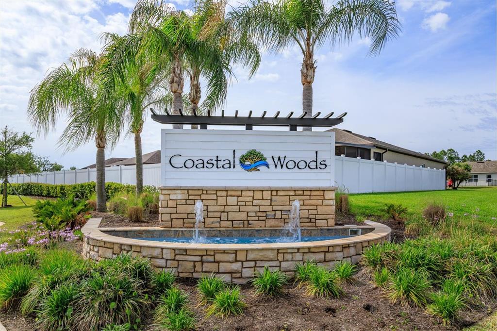 A single-story house with a tan exterior, a two-car garage, and palm trees in the yard — 3075 GIBRALTAR BOULEVARD, NEW SMYRNA BEACH, FL