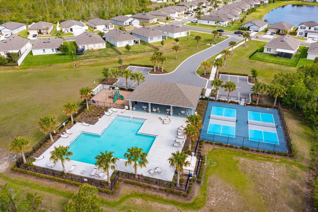 A kitchen features dark wood cabinets, granite countertops, stainless steel appliances, and a central island — 3075 GIBRALTAR BOULEVARD, NEW SMYRNA BEACH, FL