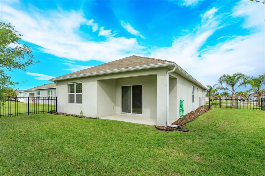 A tiled entryway features a white front door with a transom window and beige walls — 3075 GIBRALTAR BOULEVARD, NEW SMYRNA BEACH, FL