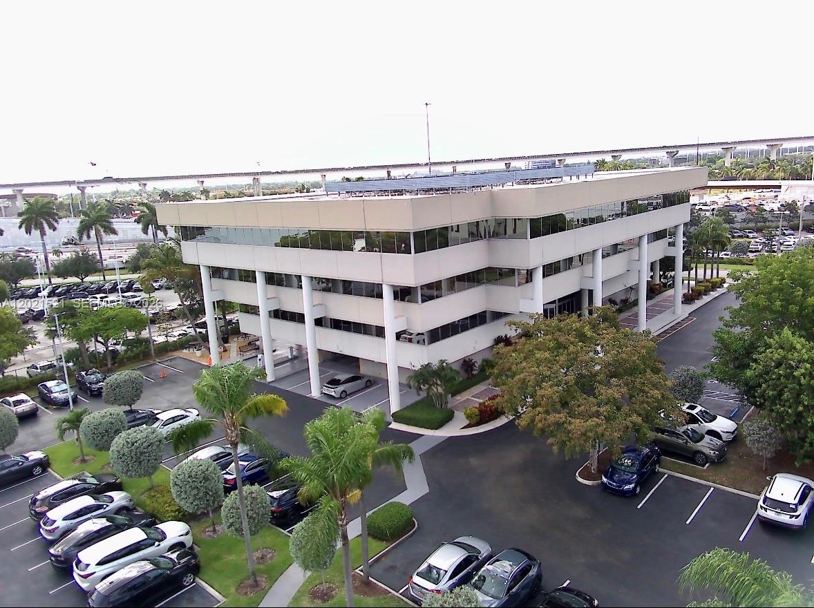 An aerial view shows a three-story commercial office building with a parking lot — 290 NW 165th St # 5C, Miami FL 33169, MIAMI, FL