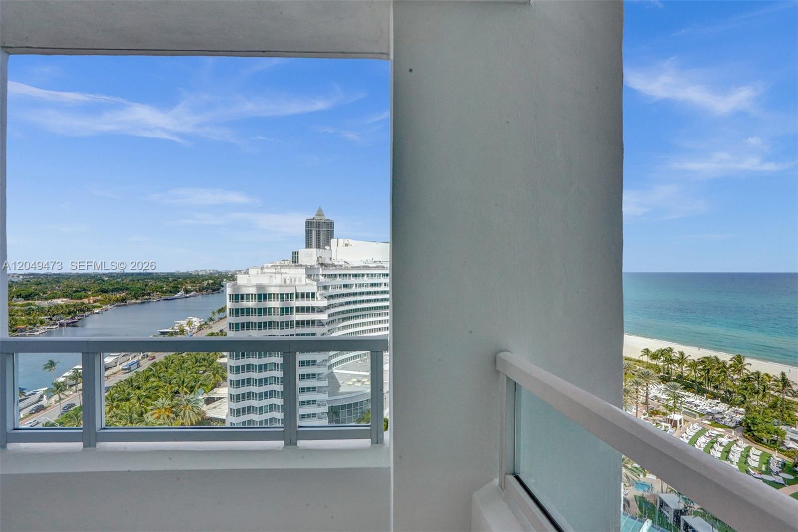 A balcony offers views of a coastal waterway, a high-rise building, and the ocean — 4401 Collins Ave # 1503, Miami Beach FL 33140, MIAMI BEACH, FL