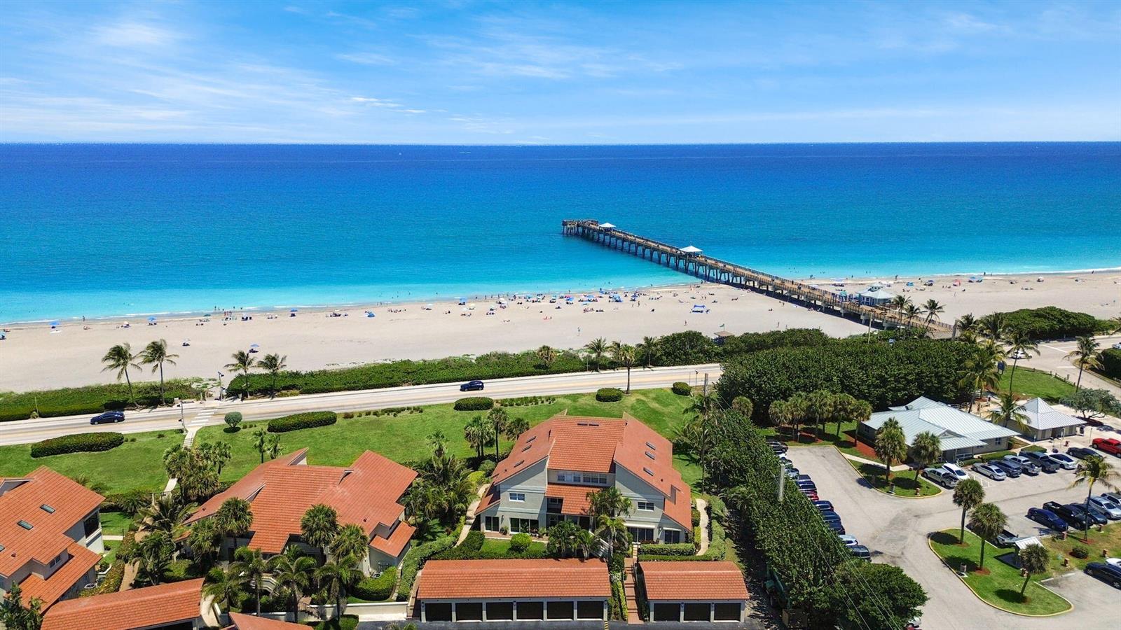 An aerial view of a coastal property with red-tiled roofs near a beach and pier — 4161 S Us Highway 1 # N1, Jupiter FL 33477, JUPITER, FL