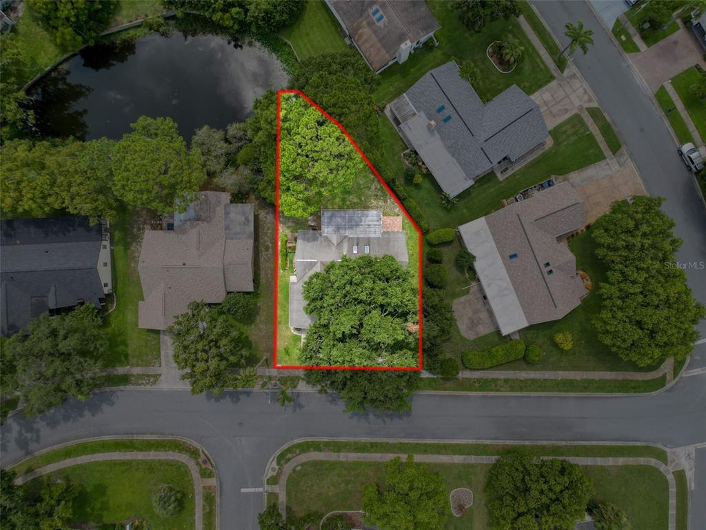 An aerial view shows a residential property with a house surrounded by trees and landscaping — 3711 ERIN BROOK DR, NEW PORT RICHEY, FL