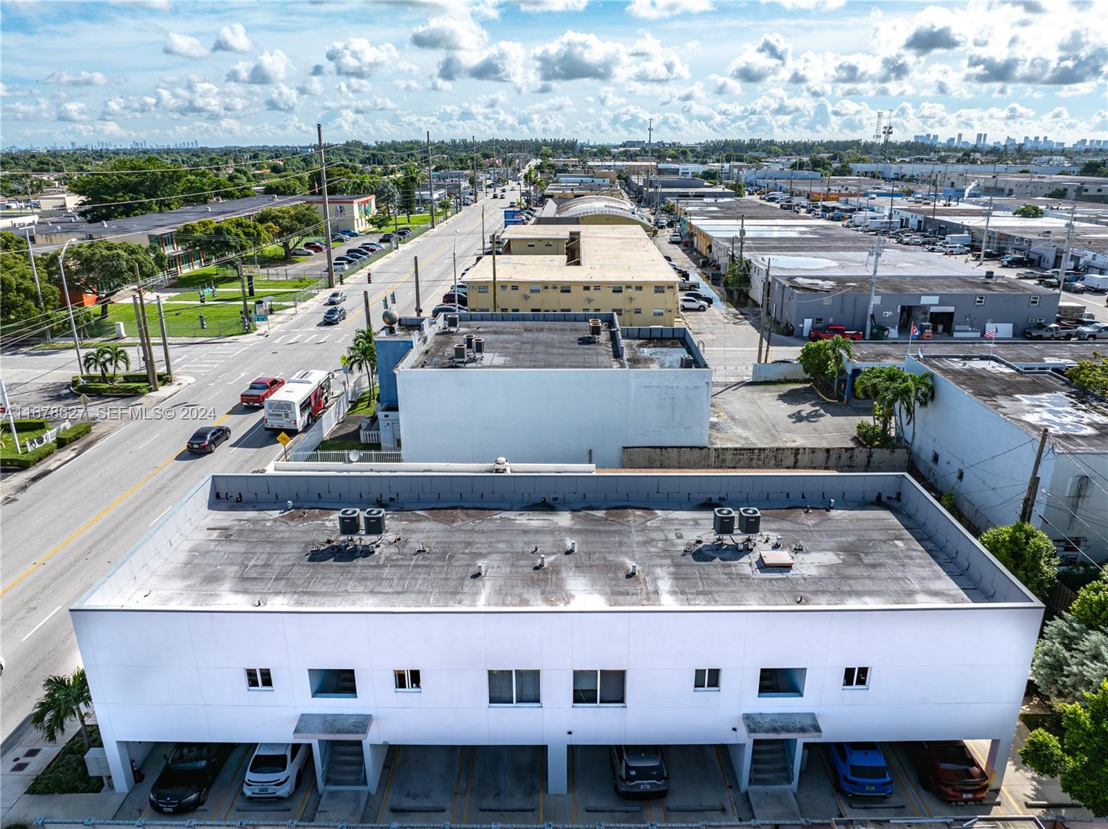 An aerial view shows a white commercial building with a flat roof and covered parking — 620 W 29th St, Hialeah FL 33012, HIALEAH, FL