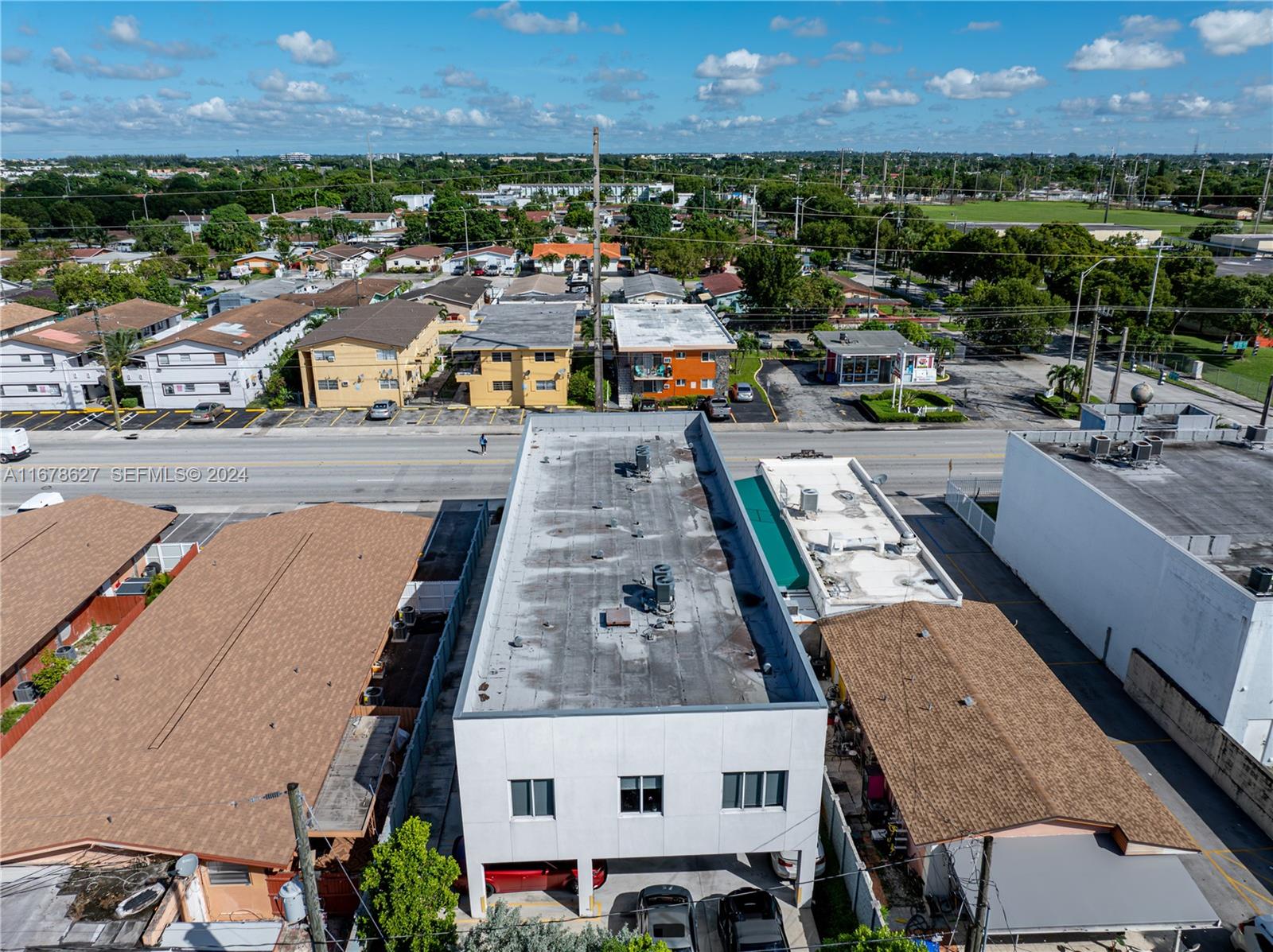 An aerial view shows a white two-story commercial building with a flat roof and parking — 620 W 29th St, Hialeah FL 33012, HIALEAH, FL